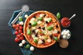 Tasty Italian pizza and ingredients on wooden background Royalty Free Stock Photo