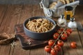 Tasty Italian spaghetti pasta with mussel, tomato, whole wheat bread and garnish on round dish and wooden plate