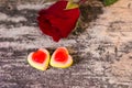 Tasty Jelly candies shaped heart with red rose nearby Royalty Free Stock Photo