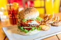 Tasty Juicy American Beef Burger Menu With Lettuce, Ketchup And Potato Chips In Fast-Food Restaurant