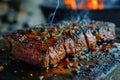 Tasty and juicy beef steak cooking over flaming grill Royalty Free Stock Photo