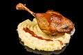 Tasty juicy duck leg with truffles and mashed potatoes with reflection