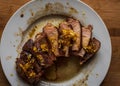 Tasty juicy roast pork tenderloin on a white plate. Overhead close-up Royalty Free Stock Photo