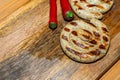 Tasty and juicy round fried sausages with stripes and red pepper with copy space