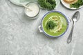 Tasty kale soup served on light grey marble table, flat lay. Space for text