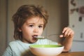 Tasty kids breakfast. Cute child eating breakfast at home. Baby eating. Good morning in Happy family. Hungry little boy Royalty Free Stock Photo