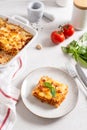 Tasty lasagna with meat and cheese on a plate, top view. Traditional italian lasagna with vegetables, basil, minced beef meat,