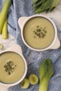 Tasty leek soup in bowls on table, flat lay Royalty Free Stock Photo