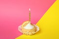 Tasty lemon cupcake with candle on two tone Royalty Free Stock Photo