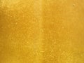 Tasty liquid background of fresh Golden honey with tiny bubbles glistening in the sun Royalty Free Stock Photo