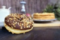 Tasty looking home baked donut with chocolate glazing and nut sprinkles Royalty Free Stock Photo