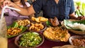 Tasty looking Indonesian food served on the table with a variety of chili sauces, rice, prawns, chicken and omlette