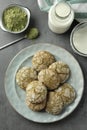 Tasty matcha cookies, powder and milk on grey table, flat lay