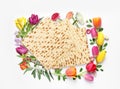 Tasty matzos and flowers on white background, top view. Passover Pesach celebration