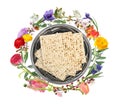 Tasty matzos and flowers on white background, top view. Passover Pesach celebration