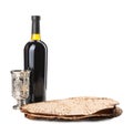 Tasty matzos, wine and goblet on white. Passover Pesach celebration Royalty Free Stock Photo