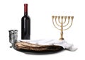 Tasty matzos, wine and menorah on white background. Passover Pesach celebration Royalty Free Stock Photo