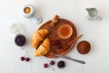 Tasty meal with fresh cherries, croissants and cocoa. Royalty Free Stock Photo