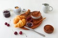 Tasty meal with fresh cherries, croissants and cocoa. Royalty Free Stock Photo