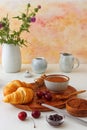 Tasty meal with fresh cherries, croissants and cocoa. Royalty Free Stock Photo