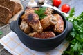 Tasty meat rolls with mushrooms in a ceramic pot on a wooden background Royalty Free Stock Photo