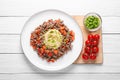 Tasty minced meat with spaghetti, vegetables and green onion on white wooden table, top view