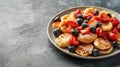 Tasty Mini Pancakes with Honey and Fresh Mixed Berries on Grey Background Royalty Free Stock Photo