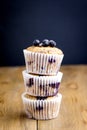Tasty Muffin Cupcakes with Blueberries on a Wooden Background Pile of Homemade Muffins Vertical Royalty Free Stock Photo