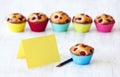 Tasty muffin near yellow greeting card Royalty Free Stock Photo