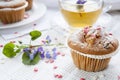 Tasty muffins with sugar hearts and cup of green tea Royalty Free Stock Photo