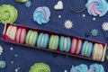 Tasty multi-colored sweet macaroons in a white gift box on a classic blue background, Top view