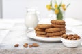 Tasty oatmeal almond cookies with jar of milk on the old marble table beautiful close-up picture light white background Royalty Free Stock Photo