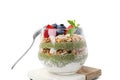 Tasty oatmeal with chia matcha pudding and berries on white tiled table, closeup. Healthy breakfast Royalty Free Stock Photo