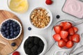 Tasty oatmeal, fresh berries, yogurt and honey on white tiled table, flat lay. Healthy breakfast Royalty Free Stock Photo