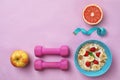 Tasty oatmeal with fresh fruits in bowl, measuring tape