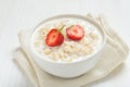 Tasty oatmeal with strawberry slices