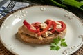 Tasty open sandwich or toast with tuna and red peppers on plate