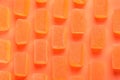 Tasty orange jelly candies on coral background, flat lay Royalty Free Stock Photo