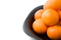 Tasty orange tangerins on black plate isolated