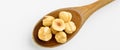 Tasty organic roasted hazelnuts and peeled filbert, on wooden spoon Royalty Free Stock Photo