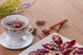 Tasty oriental sweets. Caucasian delicacy churchkhela - georgian nut treats. Served with a glass of tea and a tea pot.