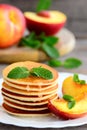 Tasty pancakes with syrup and grilled nectarines on a white plate. Home sweet pancake recipe. Summer breakfast or brunch Royalty Free Stock Photo