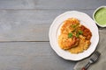 Tasty parsnip cutlets served on grey wooden table, flat lay. Space for text