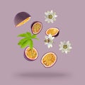 Tasty passion fruits, passiflora leaf and flowers falling on pink background