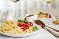 Tasty pasta with basil and tomato sauce on white table, closeup Royalty Free Stock Photo