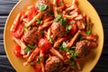 Tasty pasta Casarecce with meatballs in tomato sauce close-up on a plate. Horizontal top view Royalty Free Stock Photo