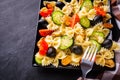 Tasty pasta salad with tomato cucumber and olives on a dark stone background Royalty Free Stock Photo