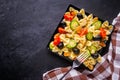 Tasty pasta salad with tomato cucumber and olives on a dark stone background Royalty Free Stock Photo