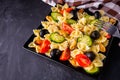 Tasty pasta salad with tomato cucumber and olives on a dark stone background Royalty Free Stock Photo