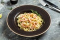 Tasty pasta with shrimps, Italian pasta fettuccine with grilled shrimps, bechamel sauce and thyme, banner, menu recipe place for Royalty Free Stock Photo